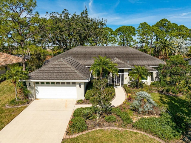 single story home featuring a garage and a front yard