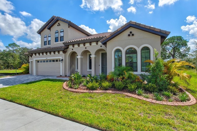 14607 Swiss Bridge Dr, Lithia, FL 33547 - mediterranean / spanish-style house with stucco siding, a tiled roof, decorative driveway, a garage, and a front lawn