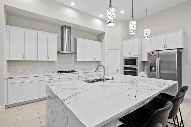 14607 Swiss Bridge Dr, Lithia, FL 33547 - kitchen with wall chimney range hood, white cabinets, a sink, gas cooktop, and stainless steel oven