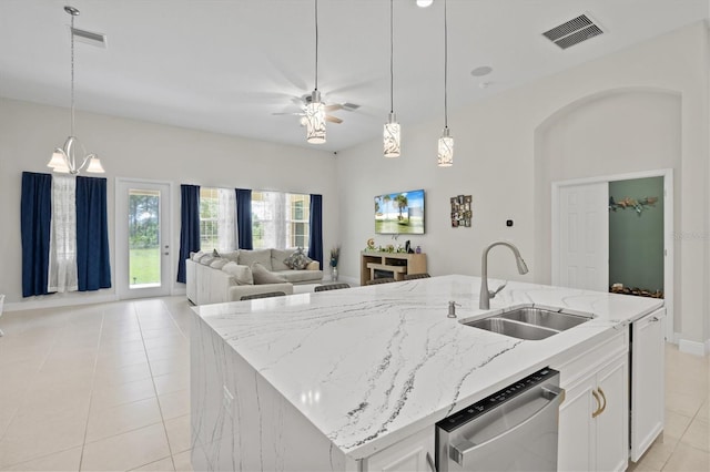 kitchen with white cabinets, dishwasher, a center island with sink, and sink