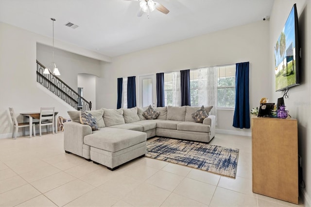 14607 Swiss Bridge Dr, Lithia, FL 33547 - tiled living area with arched walkways, stairway, ceiling fan, baseboards, and visible vents