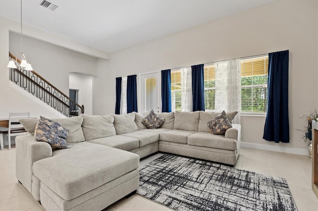 14607 Swiss Bridge Dr, Lithia, FL 33547 - living room featuring light tile patterned floors, visible vents, baseboards, arched walkways, and stairs