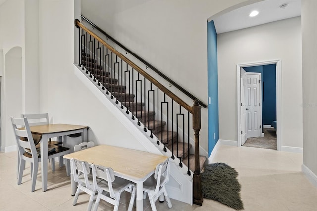 14607 Swiss Bridge Dr, Lithia, FL 33547 - stairway featuring tile patterned flooring, recessed lighting, arched walkways, and baseboards