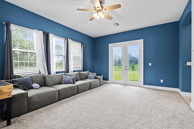 14607 Swiss Bridge Dr, Lithia, FL 33547 - carpeted living room with french doors, a healthy amount of sunlight, visible vents, and baseboards