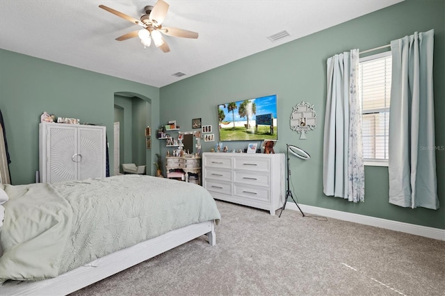 14607 Swiss Bridge Dr, Lithia, FL 33547 - bedroom with arched walkways, visible vents, light carpet, and baseboards