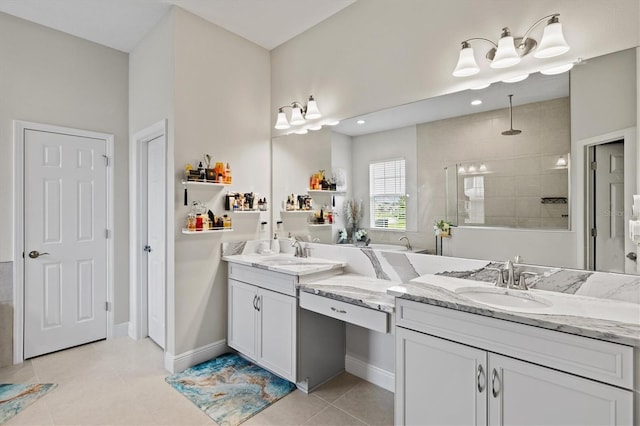 bathroom featuring a tile shower, tile patterned floors, and vanity