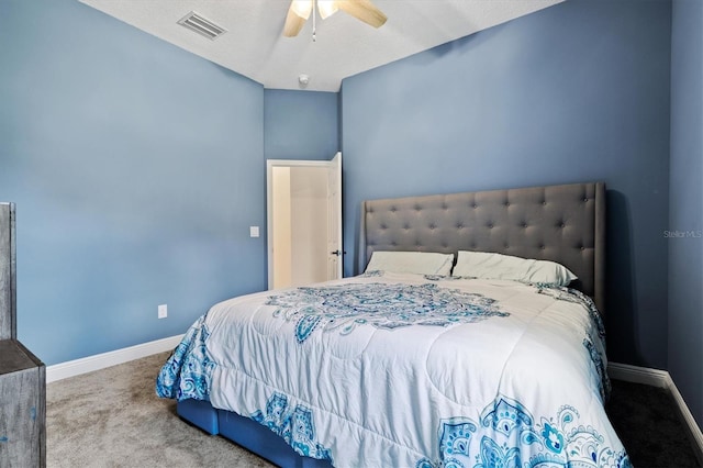 bedroom featuring ceiling fan, carpet flooring, and a textured ceiling