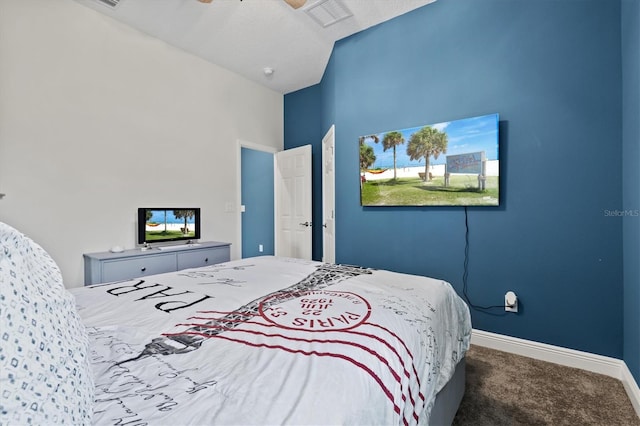 bedroom with ceiling fan, lofted ceiling, and carpet flooring