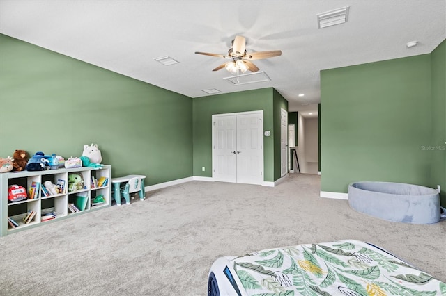 carpeted bedroom with a closet, ceiling fan, and a textured ceiling