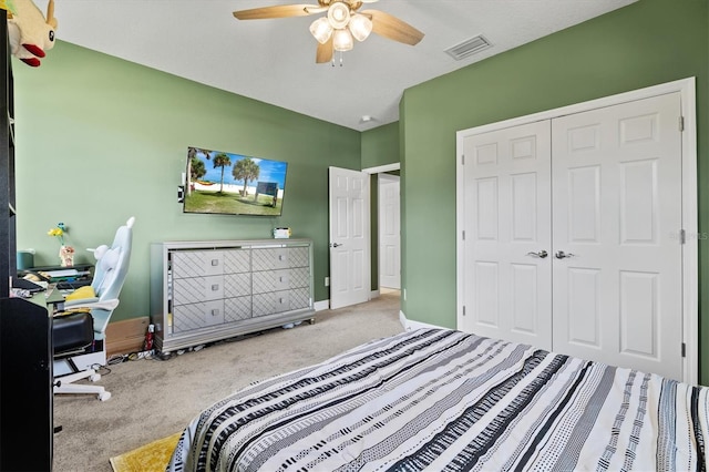 carpeted bedroom featuring a closet and ceiling fan