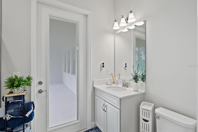 bathroom featuring vanity and toilet