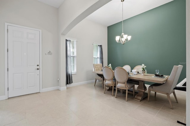 14607 Swiss Bridge Dr, Lithia, FL 33547 - dining area with light tile patterned floors, a chandelier, baseboards, and arched walkways