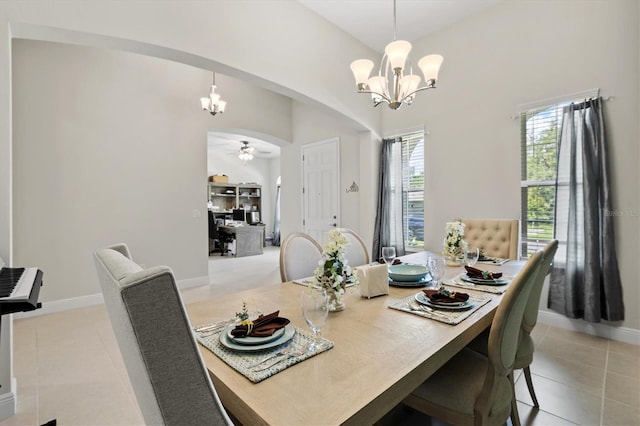 14607 Swiss Bridge Dr, Lithia, FL 33547 - dining space featuring baseboards, light tile patterned floors, arched walkways, and ceiling fan with notable chandelier