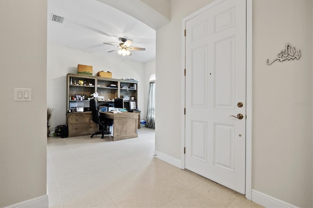 tiled home office featuring ceiling fan