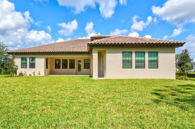 14607 Swiss Bridge Dr, Lithia, FL 33547 - rear view of house featuring a lawn and stucco siding