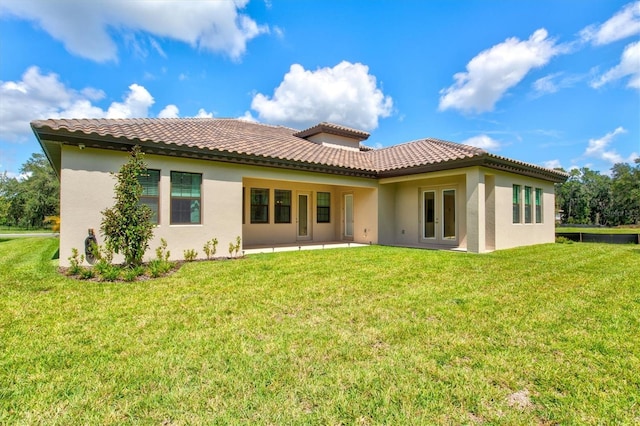 14607 Swiss Bridge Dr, Lithia, FL 33547 - rear view of house featuring stucco siding, a patio, a lawn, and french doors