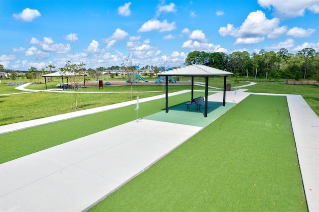 view of property's community with a playground, a gazebo, and a yard