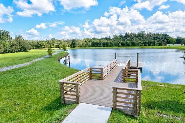 dock area with a water view and a yard