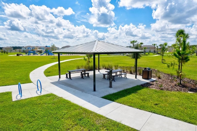 view of community with a playground, a gazebo, and a lawn