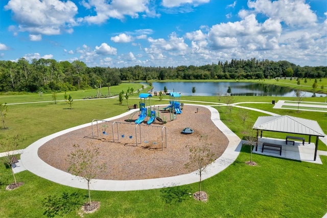 view of community featuring a water view, a playground, and a yard