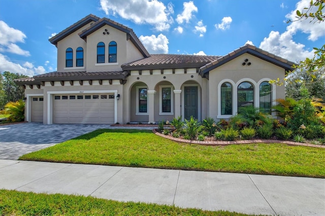 14607 Swiss Bridge Dr, Lithia, FL 33547 - mediterranean / spanish home with a tile roof, decorative driveway, a front yard, stucco siding, and a garage