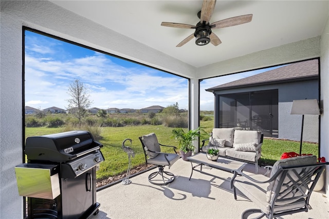 sunroom featuring ceiling fan