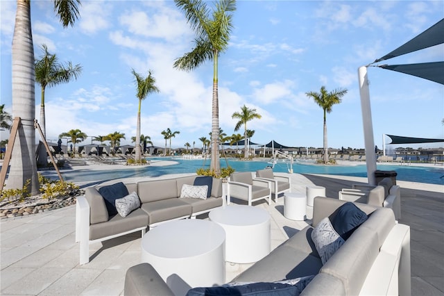 view of patio with an outdoor living space and a community pool