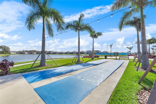 view of home's community featuring a water view and a yard