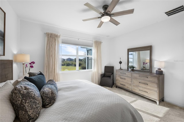 bedroom with ceiling fan and light carpet