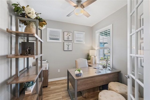 office featuring ceiling fan, light hardwood / wood-style flooring, and french doors