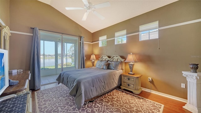 bedroom featuring access to exterior, ceiling fan, light hardwood / wood-style flooring, high vaulted ceiling, and a water view