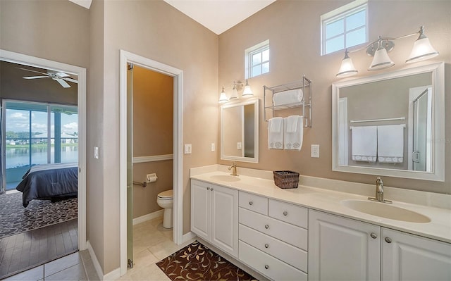 bathroom with tile patterned floors, ceiling fan, toilet, and vanity