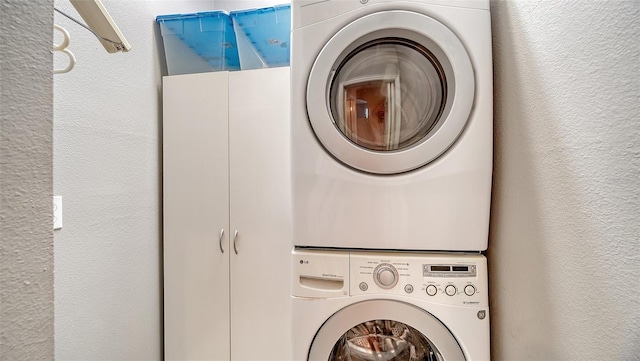 laundry area with stacked washer and clothes dryer