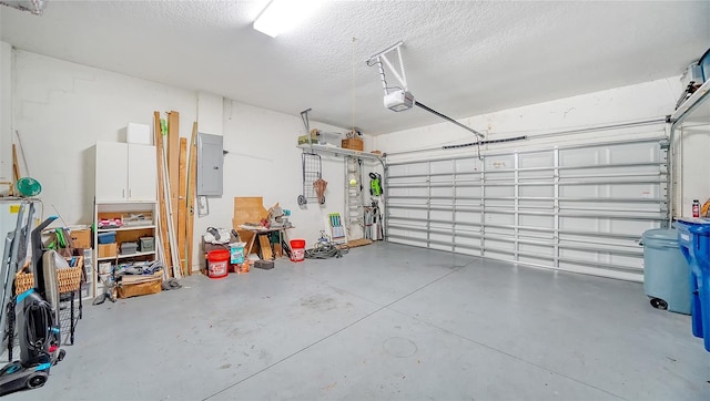 garage featuring electric panel and a garage door opener