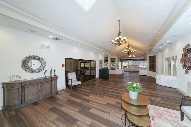 living room featuring french doors, ornamental molding, dark wood-type flooring, and a chandelier