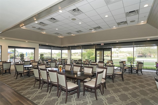 dining area featuring a drop ceiling