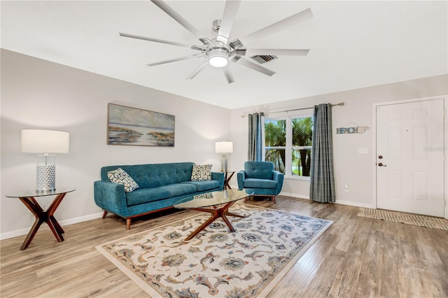 living room with ceiling fan and light wood-type flooring