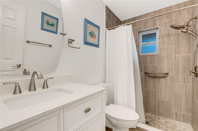 bathroom with a shower with curtain, vanity, and toilet