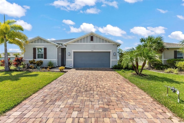 single story home with a garage and a front lawn