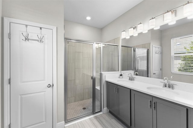 bathroom with an enclosed shower and vanity