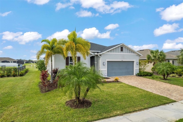 view of front of home featuring a front yard and a garage