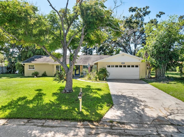 ranch-style home featuring a garage and a front lawn