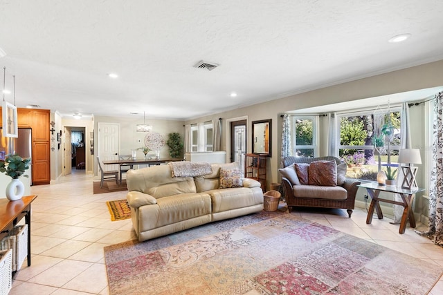 tiled living room with a textured ceiling and crown molding