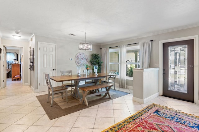 dining space featuring light tile patterned flooring, a chandelier, and ornamental molding