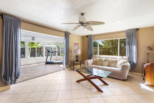 tiled living room featuring ceiling fan and a textured ceiling