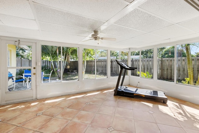 unfurnished sunroom with ceiling fan and a paneled ceiling