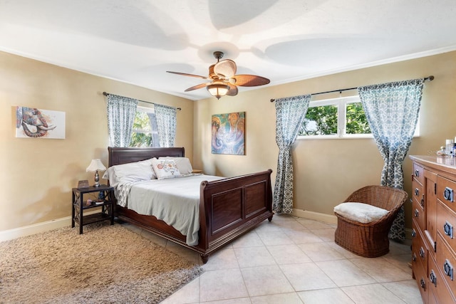 bedroom featuring multiple windows, light tile patterned flooring, and ceiling fan