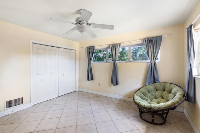 unfurnished room featuring ceiling fan and light tile patterned floors