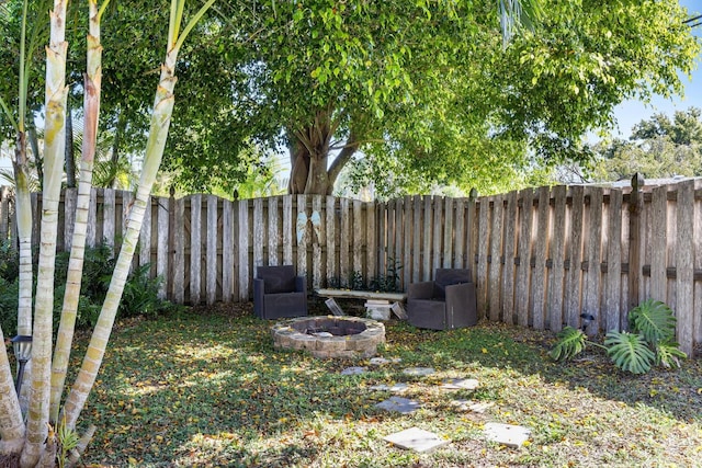 view of yard with an outdoor fire pit