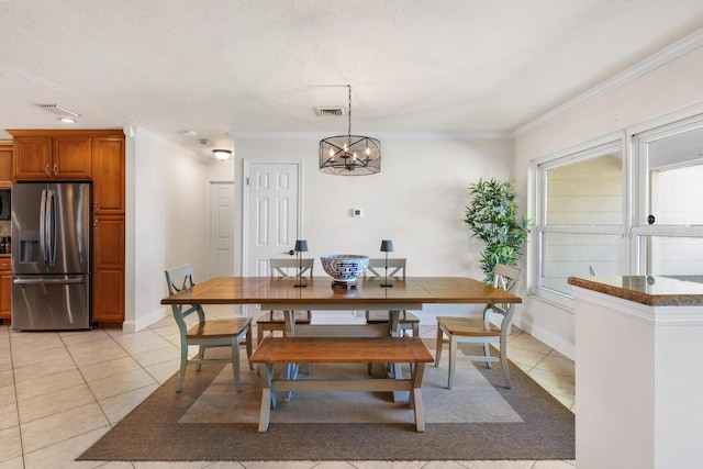 tiled dining area with a notable chandelier and ornamental molding